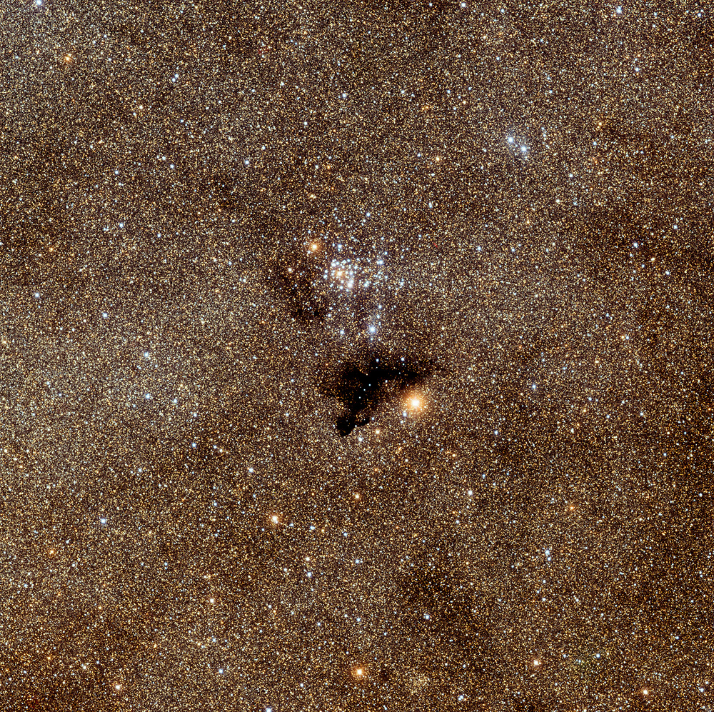 The open star cluster NGC 6520, the "Castaway Cluster", and the dark foreground nebula Barnard 86. Credit: NOAO