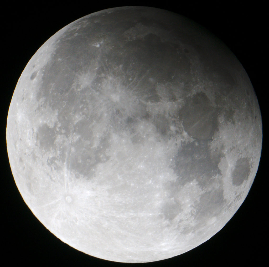 The full Moon is partially in the Earth's shadow during a penumbral lunar eclipse. Credit: Radoslaw Ziomber/Wikipedia Commons.