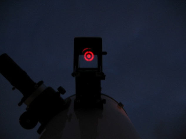 A Telrad finder aimed skyward, it's concentric circles projected onto a glass screen.